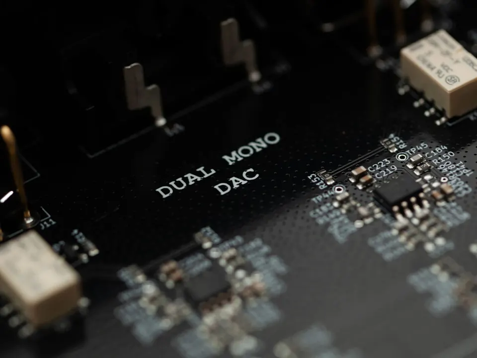 A close-up of the Preciso circuit board, with DUAL MONO DAC printed on it next to a chip.