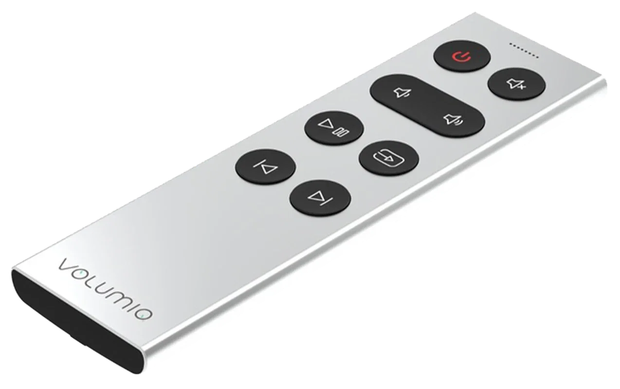 Volumio Remoto seen at an angle: a slim, silver aluminum remote with seven black buttons, one of them wide, near one end, and the Volumio name printed near the other.